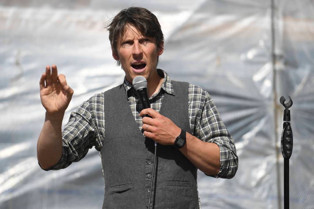 Zach Brown speaks during a Stand Strong for Climate rally in front of the Alaska State Capitol on Tuesday, Sept. 10, 2019. The rally included a march to Centennial Hall where the annual meeting of the International Forum of Sovereign Wealth Funds is taking place. The rally was organized by 350 Juneau, a local chapter of an international climate advocacy movement, 350.org. (Michael Penn | Juneau Empire)