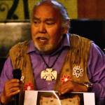 David Katzeek holds up a photo of a sun blanket at Northern Light United Church in Juneau during the Climate Change Through the Eyes of Alaska Natives forum on Sept. 12, 2019. (Peter Segall | Juneau Empire)