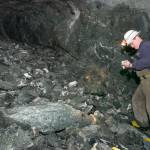 In this file photo from Feb. 2007, Kevin Torpy, Chief Engineer for Coeur Alaska, studies rock at a freshly blasted area in the tunnel coming from the Comet Mine side of the Kensington Mine project. (Juneau Empire File)