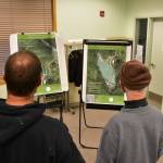 Members of the public examine maps of the proposed expansion to Coeur Alaskas Kensington Mine facilities at the Juneau Ranger District Station on Oct. 8, 2019 (Peter Segall | Juneau Empire)