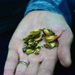 Lab manager Vanessa Watson holds gold from the quality testing process at the Kensington Mine on Monday, Oct. 14, 2019. (Peter Segall | Juneau Empire)