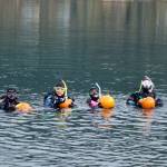 Divers at the sixth annual Spooktacular Dive and Underwater Pumpkin Carving event at Harlequin Point prepare to turn their hollowed-out pumpkins into jack-o-lanterns Saturday, Oct. 26, 2019. (Ben Hohenstatt | Juneau Empire)