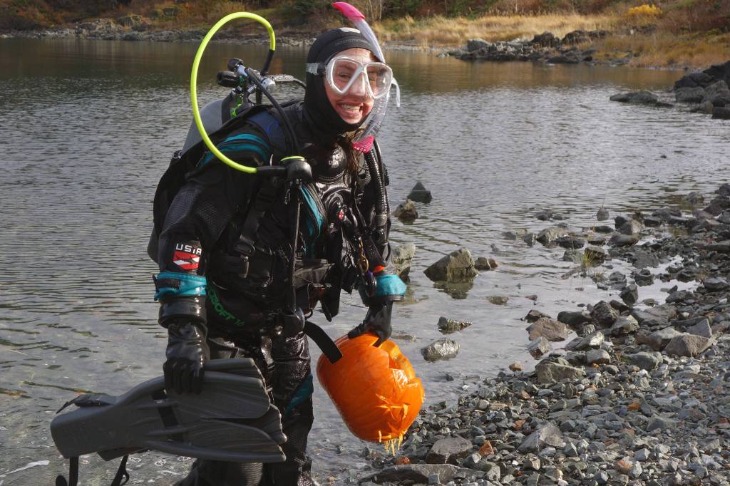 Annie Raymond returns to dry land with her jack-o-lantern titled Starry Starry Dive at the sixth annual Spooktacular Dive and Underwater Pumpkin Carving event Saturday, Oct. 26, 2019. (Ben Hohenstatt | Juneau Empire)