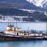 The derelict tugboat Lumberman lies moored to a city-owned pier on Sunday after coming adrift and grounding near Norway Point downtown. (Michael S. Lockett | Juneau Empire)
