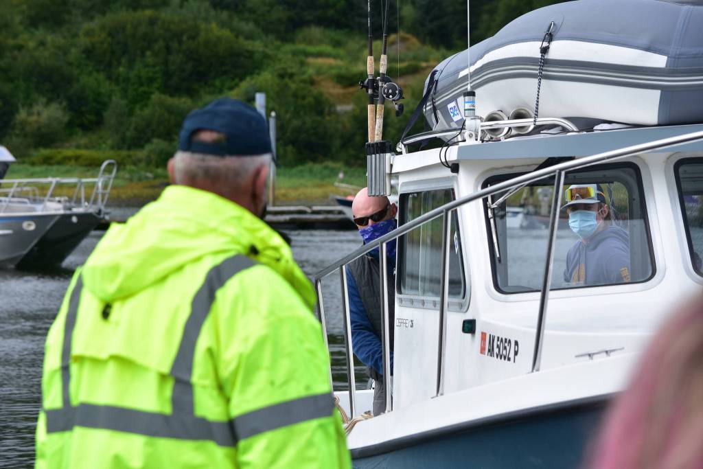 A boat pulls into Statter Harbor in Auke Bay to deliver scholarship fish or salmon caught during the derby which wont be entered into the main competition on Sunday, Aug. 16, 2020. Those fish are exchanged for raffle tickets and their holders can be awarded prizes. (Peter Segall / Juneau Empire)