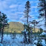 This photo taken on the Ohmer Creek Trail in Petersburg shows a snowy muskeg meadow with mountain in background, and blue sky with clouds on Jan. 31, 2021. (Courtesy Photo / Cindi Lagoudakis)