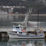 The crew of the fishing vessel San Juan release a memorial wreath into the Gastineau Channel during the 31st annual Blessing of the Fleet and Reading of Names at the Alaska Commercial Fishermens Memorial in Juneau on May 1, 2021. (Michael S. Lockett / Juneau Empire)