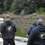 Dock volunteers prepare to greet a boat at the Mike Pusich Douglas Harbor weigh station for the 75th annual Golden North Salmon Derby on Saturday, Aug. 14, 2021. This boat turned out not to be involved in the derby, but the volunteers were ready nonetheless. (Peter Segall / Juneau Empire)