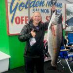 Tiffany Listberger poses with her 31.7-pound king salmon turned in at the Auke Bay weight station on Sunday. According to provisional results, Listberger is the winner of the 75th annual Goldern North Salmon Derby. (Courtesy photo / Derek Listeberger)