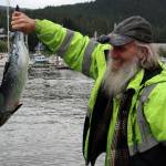 Eric Kirchner drops off one of several salmon during the 75th annual Golden North Salmon Derby. (Ben Hohenstatt / Juneau Empire)
