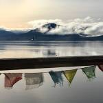 Tattered prayer flags fly above high tide in mid-October in Tenakee Springs. (Courtesy Photo / Linda Buckley)