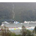 The Norwegian Encore sails past Douglas Island on Sept. 8, 2021. The Encore was visiting Juneau as part of an abbreviated cruise season this summer after COVID-19 canceled the 2020 season. The City and Borough of Juneau recently conducted an online survey for residents to share their views on the tourism industry. Local cruise critics say they are eagerly awaiting survey results. (Dana Zigmund/Juneau Empire)