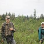 Discovery Southeast naturalists Richard Carstensen speak to the group about the origins of the wetlands during a break on the hike. (Clarise Larson // Juneau Empire)