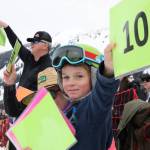 Slush Cup judge Corbin Hall, 7, gives his mom a perfect score as she glides over the pond Saturday afternoon. (Clarise Larson / Juneau Empire)