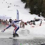 A snowboarder stays afloat on the skim pond at Eaglecrest Ski Area as they partake in the return of the Slush Cup Saturday afternoon. (Clarise Larson / Juneau Empire)
