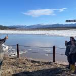 Ryan Becker, a teacher at the Eagle school, takes a photo of his students as part of a continuing Yukon River ice study on May 12, 2023. (Courtesy Photo / Ned Rozell)