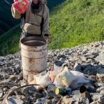 Glaciologist Martin Truffer holds raisins that had been preserved for more than 20 years in a barrel cache scientists left on Fireweed rock glacier near McCarthy. (Photo by Ned Rozell)