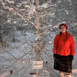 Annemarie Timling stands near a birch tree she helped choose to honor her father Ronnie Daanen, who died in a helicopter crash in July. (Photo by Ned Rozell)