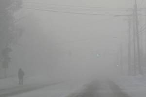 A man walks a Fairbanks street during an ice-fog episode in January 2012. (Photo by Ned Rozell)