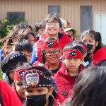 The Angoon Youth Dance Group files into the Angoon Elementary School gymnasium. (Jasz Garrett / Juneau Empire)