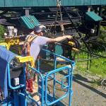 An employee performs maintenance work on a chairlift at Eaglecrest Ski Area in late June. (Eaglecrest Ski Area photo)