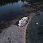 A likeness of a French model created largely with shells and black limestone rock is seen on a beach on an island near Kake. (Photo by Blake Byers)