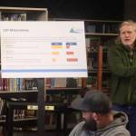 Alan Steffert, a project engineer for the City and Borough of Juneau, explains alternatives considered when assessing infrastructure improvements including utilities upgrades during a meeting to discuss a proposed fee increase Thursday night at Thunder Mountain Middle School. (Mark Sabbatini / Juneau Empire)
