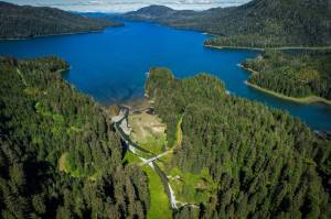 An aerial view of Láan Yík (Channel inside or Port Camden) with cars and people gathered on the bridge over Yéil Héeni (Ravens Creek) during a May 2024 convening on Kuiu Island. Partners that comprise the Ḵéex̱ Ḵwáan Community Forest Partnership and staff from the Tongass National Forest met to discuss priorities for land use, stream restoration, and existing infrastructure on the north Kuiu road system. (Photo by Lee House)