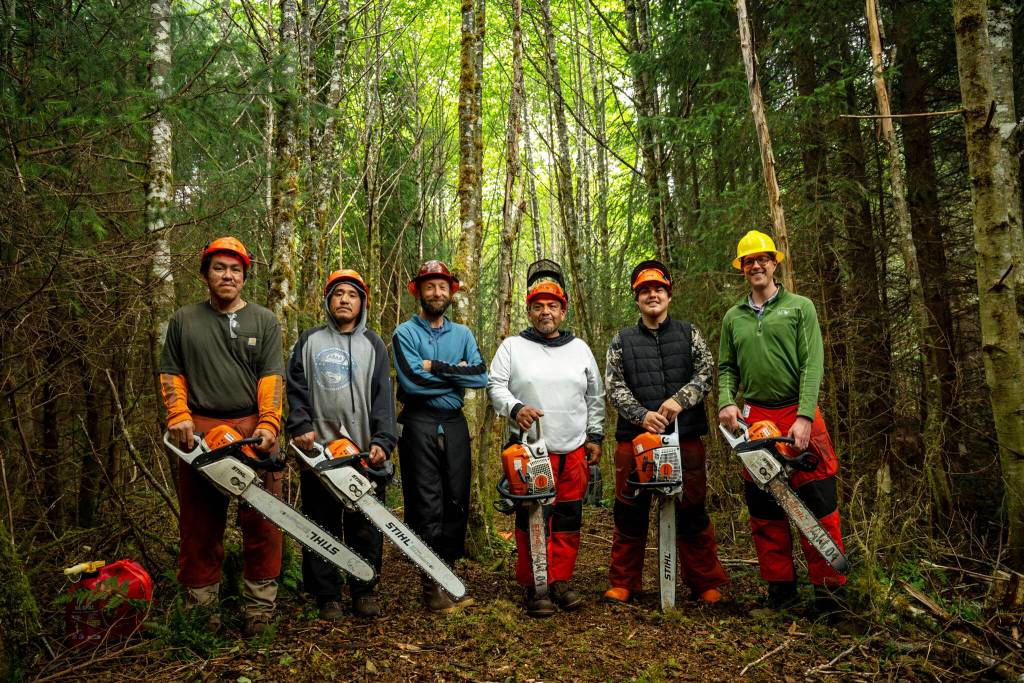 The Angoon stewardship crew hosted by Kootznoowoo Inc. alongside Southeast Alaska Watershed Coalition (SAWC) and the U.S. Forest Service. From left to right: Roger Williams, Walter Washington, Rob Cadmus (SAWC), Jamie Daniels, Justin Turner, Dean Anderson (Forest Service). The crew and partners kicked off work on the Cube Cove restoration project on Admiralty Island in 2024. (Photo by Lee House)