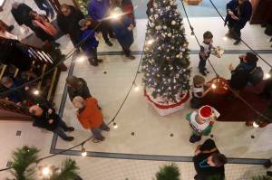 Members of the Juneau Ski Team offer cookies and other treats to people in the Senate Mall during this years Gallery Walk on Friday, Dec. 6. (Mark Sabbatini / Juneau Empire file photo)