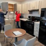 Legislative Affairs Agency Executive Director Jessica Geary and Juneau Real Estate property manager Elizabeth Clayton show off the new kitchen in a studio apartment. The building was purchased, renovated, furnished and donated to the state agency through the Juneau Capitol Fund and the nonprofit philanthropic Juneau Community Foundation. (Laurie Craig / Juneau Empire)