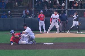 Juneau-Douglas High School: Yadaa.at Kalé shortstop Brandon Casperson tags out Sitka runner Tyson Bartolaba on a throw from catcher JJ McCormick during the Crimson Bears 5-1 loss to the Wolves on Friday at Adair Kennedy Memorial Park. (Klas Stolpe / Juneau Empire)