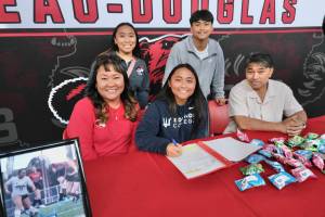 Juneau-Douglas High School: Yadaa.at Kalé senior Milina Mazon signs a Northwest Athletic Conference Letter of Intent on Monday in the JDHS commons to attend Edmonds College in Lynnwood, Washington, and play soccer for the Tritons. Shown from left are mother Heidi, sister Asianna, Milina, brother Sam and father Sonny. (Klas Stolpe / Juneau Empire)