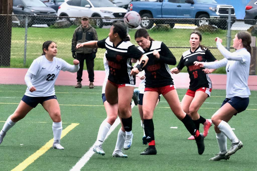 Juneau-Douglas High School: Yadaa.at Kalé junior Kenzie Simonson (7) heads a shot as senior Milina Mazon (11), freshman Ayla Erickson (16) and Soldotna freshman Mykah Walgenbach (22) and sophomore Teagen Kobylarz (2) react during the Crimson Bears 2-1 loss to the Stars on Thursday at Adair Kennedy Memorial Park. (Klas Stolpe/ Juneau Empire)