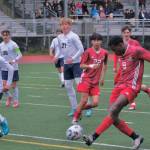 Juneau-Douglas High School: Yadaa.at Kalé senior Ahmir Parker (9) scores past Soldotna freshman Trevin Moore (18) during the Crimson Bears 3-0 win over the Stars on Thursday at Adair Kennedy Memorial Park. (Klas Stolpe / Juneau Empire)