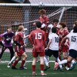 Juneau-Douglas High School: Yadaa.at Kalé senior Reed Maier (19) heads a Soldotna corner kick away during the Crimson Bears 3-0 win over the Stars on Thursday at Adair Kennedy Memorial Park. (Klas Stolpe / Juneau Empire)