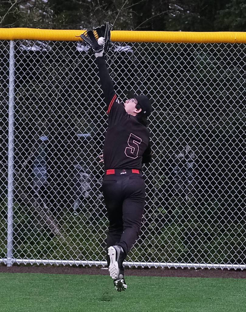 Juneau-Douglas High School: Yadaa.at Kalé senior Jacob Katasse (5) catches a fly ball out during the Crimson Bears baseball senior night against Ketchikan Saturday at Adair-Kennedy Memorial Park. (Klas Stolpe / Juneau Empire)