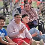 Juneau-Douglas High School: Yadaa.at Kalé junior Richard Tupou flashes a peace sign while sitting with family members during the Capital City Invitational this year. Tupou is among the shot put favorites for this weekend's Region V championships at Thunder Mountain Middle School. (Klas Stolpe / Juneau Empire)