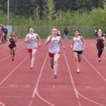 Juneau-Douglas High School: Yadaa.at Kalé freshman sprinter Bella Connally (4) wins the girls 100-meters in a Crimson Bears sweep as classmates Lydia Goins (7), Addie Hartman (5) and Shandiin Frommherz (3) trail her across the finish during the Region V Track & Field Championships at Juneaus Thunder Mountain Middle School on Friday. (Klas Stolpe / Juneau Empire)