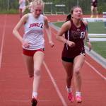 Juneau-Douglas High School: Yadaa.at Kalés Sigrid Eller and Ketchikans Carol Frey cross the finish line of the girls 800 meter race during the Region V Track & Field Championships at Juneaus Thunder Mountain Middle School on Friday. Frey won by .02 seconds. (Klas Stolpe / Juneau Empire)