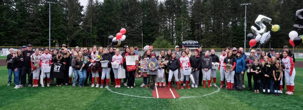 The Juneau-Douglas High School: Yadaa.at Kalé Crimson Bears softball seniors and family members pose for a photo Saturday at Adair-Kennedy Memorial Park during senior honors. (Klas Stolpe / Juneau Empire)