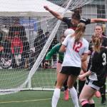 Juneau-Douglas High School: Yadaa.at Kalé freshman Ayla Erickson blocks a Wasilla corner kick in the box as junior keeper Alba Muir and seniors Ella Orsborn, left, Adelyn Buss (3), Natalie Travis and Lola Hines (2) look on during the Crimson Bears senior appreciation game Saturday at Adair-Kennedy Memorial Park. (Klas Stolpe / Juneau Empire)