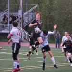 Juneau-Douglas High School: Yadaa.at Kalé senior Reed Maier connects with a corner kick that would score during Saturdays Crimson Bears senior appreciation game at Adair-Kennedy Memorial Park. (Klas Stolpe / Juneau Empire)