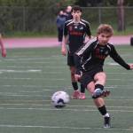 Juneau-Douglas High School: Yadaa.at Kalé senior Kai Ciambor hits a penalty kick to break the Crimson Bears career scoring record during Saturdays Crimson Bears senior appreciation game at Adair-Kennedy Memorial Park. (Klas Stolpe / Juneau Empire)
