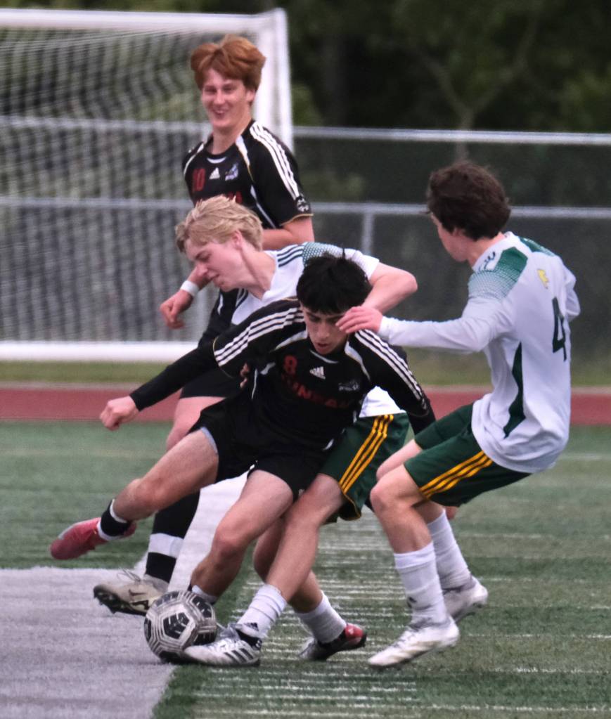 Juneau-Douglas High School: Yadaa.at Kalé senior Kellen Chester (8)battles for a ball during the Crimson Bears win over Service to open the 2025 ASAA/First National Bank Alaska Soccer State Championships at Wasilla High School on Thursday, May 29, 2025. (Klas Stolpe / Juneau Empire)