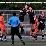 Juneau-Douglas High School: Yadaa.at Kalé sophomore Erik Thompson (21), junior Elliot Welch (16) and seniors Kellen Chester (8) and Reed Maier (20) stop a West Anchorage corner kick during the Crimson Bears 3-2 loss to the Eagles on Friday in the 2025 ASAA/First National Bank Alaska Soccer State Championship semifinals at Wasilla High School. (Klas Stolpe / Juneau Empire)