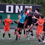Juneau-Douglas High School: Yadaa.at Kalé seniors Reed Maier (20) and Kellen Chester (8) battle for a header in the West Anchorage box during the Crimson Bears 3-2 loss in extra time to the Eagles in the 2025 ASAA/First National Bank Alaska Soccer State Championship semifinals Friday at Wasilla High School. (Klas Stolpe / Juneau Empire)
