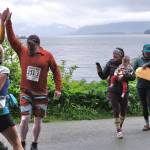 Team Babes With Babies make a handoff at the Auke Village Recreation Area during the Seacoast Relay on Sunday, June 8, 2025. (Klas Stolpe / Juneau Empire)