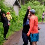 Team Four Moms, One Dad make a hand off at Lena Beach Picnic Area during the Seacoast Relay on Sunday, June 8, 2025. (Klas Stolpe / Juneau Empire)