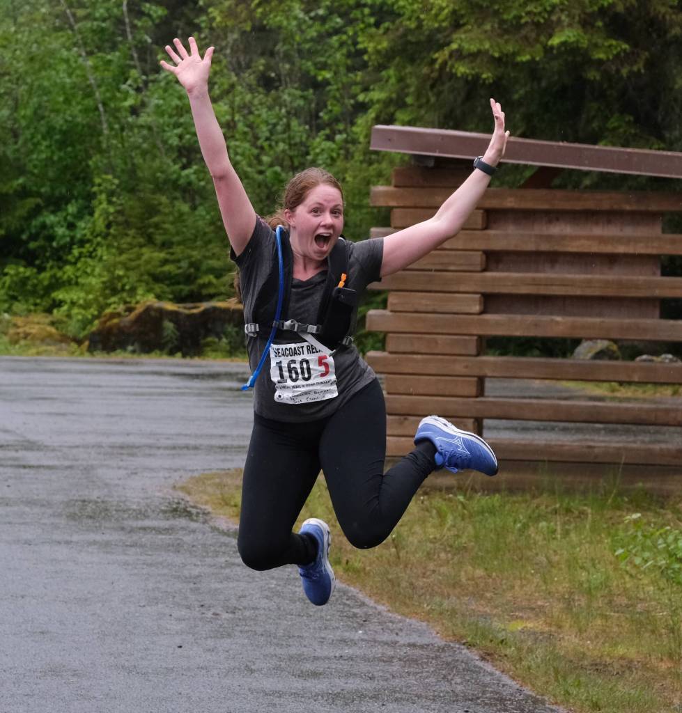 Samantha Blommer of team Sole Sisters jumps for joy as she approaches the finish line of the Seacoast Relay at the Eagle Beach State Park outer beach picnic shelter on Sunday, June 8, 2025. (Klas Stolpe / Juneau Empire)
